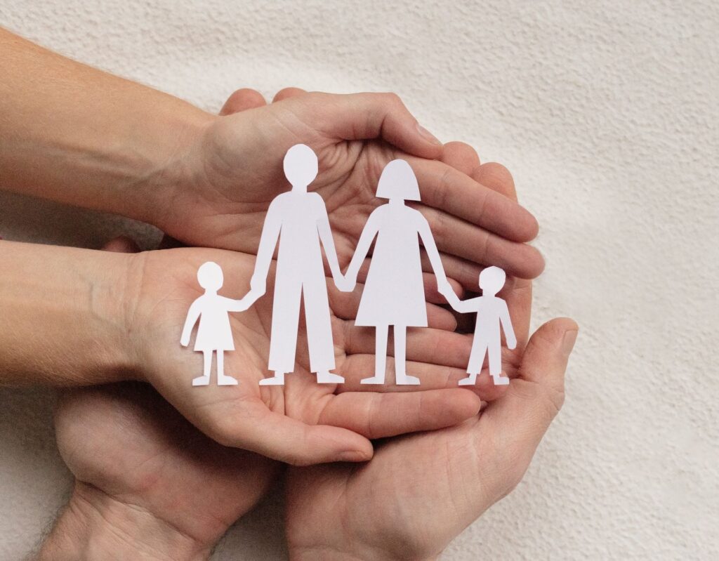 family concept, parents with children from paper, insurance, family care and protection